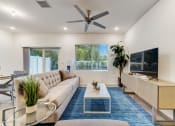 Thumbnail 9 of 30 - Boatman Hammock Townhomes in Lake Worth, FL photo of  a living room with a couch and a tv