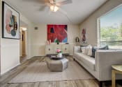Thumbnail 1 of 15 - Derby Park Apartments in Daytona Beach, FL photo of a living room with a couch and a coffee table