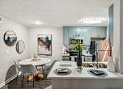Thumbnail 4 of 34 - A modern kitchen with a dining table and chairs.