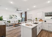Thumbnail 5 of 45 - A modern kitchen with white cabinets and a wooden floor.