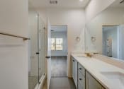 Thumbnail 5 of 14 - Luxury Four Bedroom Townhomes in Avondale Estates, GA - Henley Avondale –bathroom with a large sink and a shower