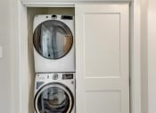 Thumbnail 31 of 56 - a front loading washer and dryer in a laundry room