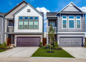 Thumbnail 17 of 19 - a house with two garage doors and a yard