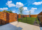 Thumbnail 2 of 19 - Two-Bedroom Homes for Rent in Houston, TX - East Heights - Dog Park with Green Grass, Trees, and Gated Fence.