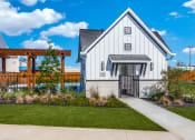 Thumbnail 18 of 19 - a white home with a walkway and a wooden fence