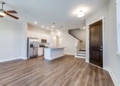 Thumbnail 6 of 19 - 	Houses for Rent in Houston, TX - East Heights - Living Room with Open Floor Plan, Ceiling Fan, Wood-Style Flooring, and Front Door.