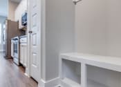 Thumbnail 12 of 19 - a renovated kitchen with white cabinets and a wood floor