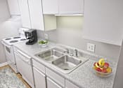 Thumbnail 6 of 16 - Greentree Apartments in Savannah, GA photo of a kitchen with white cabinets