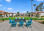 Thumbnail 7 of 28 - Apartments for Rent Moreno Valley - Ardella on Chagall - BBQ Area with Grilling Stations Under Pergolas, Manicured Grass Lawn, Cornhole Boards, Table and Chairs