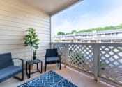 Thumbnail 8 of 20 - a balcony with two chairs and a potted plant