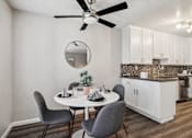 Thumbnail 14 of 32 - A dining room with a table, chairs, and a ceiling fan.