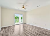 Thumbnail 15 of 48 - A bright Hawks Landing living space in Hickory NC featuring a sliding glass door that opens to a backyard