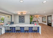 Thumbnail 19 of 34 - a conference room with a white counter and blue chairs