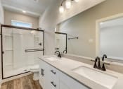 Thumbnail 26 of 56 - a bathroom with a large mirror and two sinks