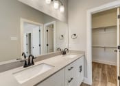 Thumbnail 27 of 56 - a bathroom with two sinks and a large mirror
