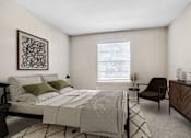 Thumbnail 8 of 17 - Apartments for Rent in Houston, TX 77036 – Artisan West – A bedroom with a bed, chair, and a plant.