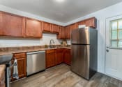 Thumbnail 9 of 17 - a kitchen with stainless steel appliances and wooden cabinets
