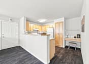 Thumbnail 10 of 47 - A kitchen with a white counter and wooden cabinets.