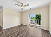Thumbnail 14 of 48 - A bright Hawks Landing living space in Hickory NC featuring a ceiling fan and sliding glass doors