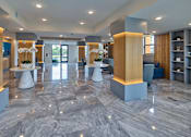 Thumbnail 26 of 36 - A spacious lobby with marble floors and modern furniture.