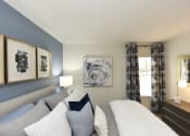 Thumbnail 13 of 27 - a blue and white bedroom with a couch and a window