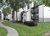 Thumbnail 26 of 27 - the walkway in front of an apartment building