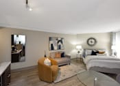 Thumbnail 10 of 51 - A modern bedroom with a large bed and a yellow armchair.