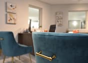 Thumbnail 26 of 51 - A blue chair with a gold handle is in the foreground of a room with a desk and a mirror.