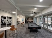 Thumbnail 20 of 51 - A room with a pool table and chairs.