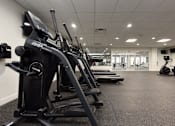 Thumbnail 29 of 51 - A gym with treadmills and elliptical machines.