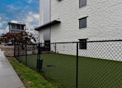 Thumbnail 40 of 51 - A white building with a black fence in front.