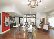 Thumbnail 23 of 27 - a living room with a dining room and a kitchen