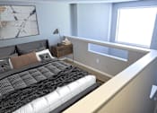 Thumbnail 8 of 16 - Greentree Apartments in Savannah, GA photo of a bedroom with a bed and a ledge with a window