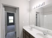 Thumbnail 10 of 21 - an empty bathroom with a large mirror and two sinks