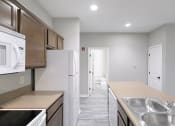 Thumbnail 6 of 21 - an empty kitchen with stainless steel appliances and a white refrigerator