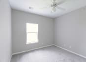 Thumbnail 8 of 21 - an empty room with a ceiling fan and a window