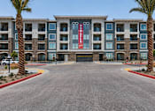 Thumbnail 4 of 21 - A large building with a red sign that says "NOW OPEN" is surrounded by palm trees.