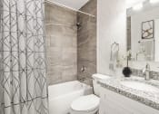Thumbnail 4 of 28 - Addison Lane Apartment homes in Gainesville Florida photo of a bathroom with a shower toilet and sink