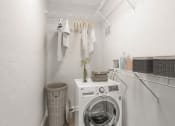 Thumbnail 5 of 28 - Addison Lane Apartment homes in Gainesville Florida photo of a small laundry room with a washing machine and dryer