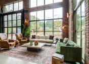 Thumbnail 9 of 16 - Affinitee at Stone Mountain Apartments photo of seating area with large windows