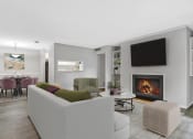 Thumbnail 12 of 16 - Affinitee at Stone Mountain Apartments photo of a living room with a couch and a fireplace