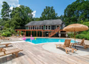Thumbnail 10 of 16 - Affinitee at Stone Mountain Apartments photo of a swimming pool and a deck with chairs