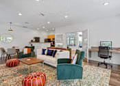 Thumbnail 18 of 34 - A living room with a green chair and a white couch.