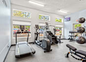 Thumbnail 21 of 34 - A gym with treadmills, exercise balls, and other equipment.