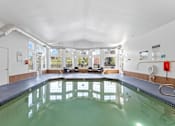 Thumbnail 23 of 34 - A large indoor swimming pool with a glass bottom.