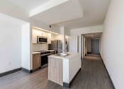 Thumbnail 11 of 37 - Pet-friendly home featuring a modern kitchen with a spacious island, energy-efficient appliances, and sleek countertops in a Miami Beach apartment.