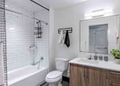 Thumbnail 19 of 37 - Pet-friendly home featuring a bathroom with a shower tub combo, modern fixtures, and clean design in a Miami Beach apartment.