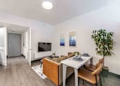 Thumbnail 6 of 37 - Spacious living room in a pet-friendly Miami Beach apartment featuring wood-style vinyl plank flooring, modern design, and natural lighting.