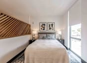 Thumbnail 17 of 37 - Bright bedroom in a Miami Beach pet-friendly apartment featuring large windows, neutral tones, and spacious layout for comfortable urban living.