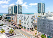 Thumbnail 35 of 37 - Elevated view of a Miami Beach apartment property with multiple buildings and close proximity to city amenities.